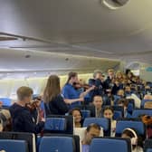 Members of the Ayrshire Fiddle Orchestra playing tunes to passengers on their outbound KLM flight to Atlanta (pic: Ayrshire Fiddle Orchestra)