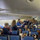 Members of the Ayrshire Fiddle Orchestra playing tunes to passengers on their outbound KLM flight to Atlanta (pic: Ayrshire Fiddle Orchestra)