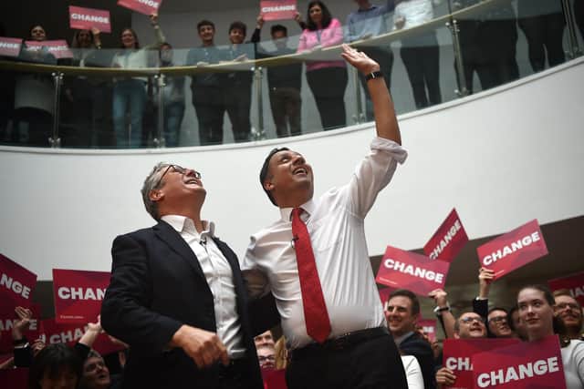 Keir Starmer and Anas Sarwar wave at supporters as they launch Scottish Labour's general election campaign (Photo by ANDY BUCHANAN / AFP)