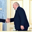 Russia's President Vladimir Putin and Belarus' President Alexander Lukashenko shake hands during a signing ceremony following a meeting of the Supreme State Council of the Union State of Russia and Belarus last month.