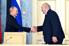 Russia's President Vladimir Putin and Belarus' President Alexander Lukashenko shake hands during a signing ceremony following a meeting of the Supreme State Council of the Union State of Russia and Belarus last month.