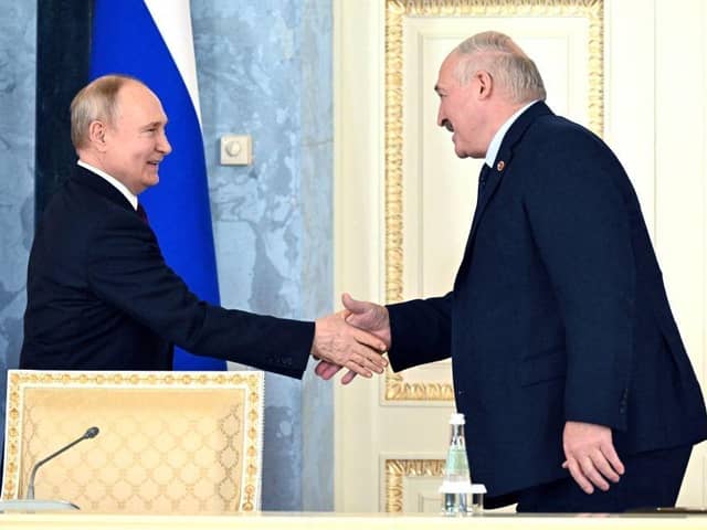 Russia's President Vladimir Putin and Belarus' President Alexander Lukashenko shake hands during a signing ceremony following a meeting of the Supreme State Council of the Union State of Russia and Belarus last month.