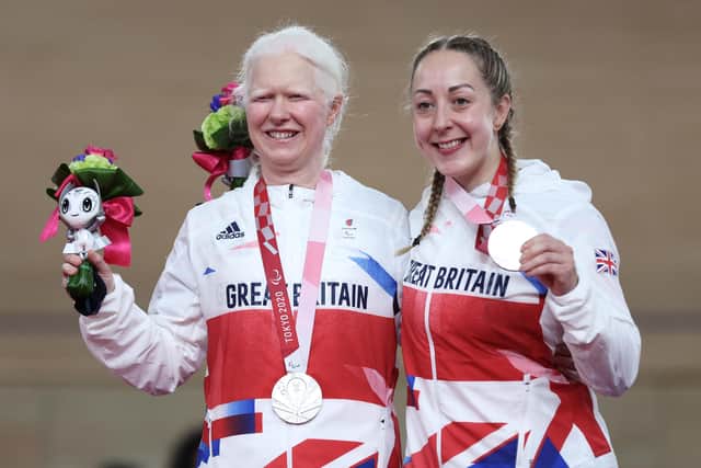 Silver medalists Aileen McGlynn (L) and pilot Helen Scott of Team Great Britain celebrate on the podium during the medal ceremony for the Track Cycling Women's B 1000m Time Trial on day 2 of the Tokyo 2020 Paralympic Games at Izu Velodrome. (Photo by Kiyoshi Ota/Getty Images)