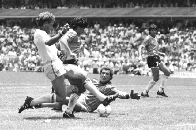 Diego Maradona scores the 'goal of the century' against England in the 1986 World Cup (Picture: AP Photo)