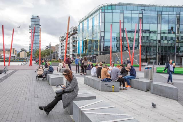 People take a lunch break in the business and financial sector of Dublin City centre