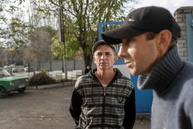 Ukranian men talk to journalists after they managed to flee from the Russian occupied territory of Kherson, earlier this month.