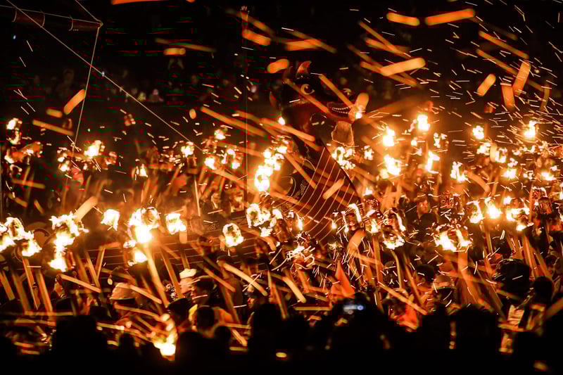 Participants take part in the Up Helly Aa festival parade through the streets of Lerwick, Shetland Islands on January 31, 2023. - Up Helly Aa celebrates the influence of the Scandinavian Vikings in the Shetland Islands and culminates with up to 1,000 'guizers' (men in costume) throwing flaming torches into their Viking longboat and setting it alight later in the evening. (Photo by Andy Buchanan / AFP)