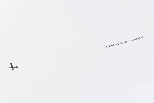 The plane with the banner flying above Tannadice. Picture: SNS