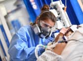 An NHS worker cares for a patient with Covid in intensive care (Picture: Neil Hall/pool/AFP via Getty Images)