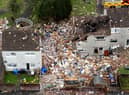 The blast site remains fenced off, with three of the four worst-affected houses knocked down while one stands empty