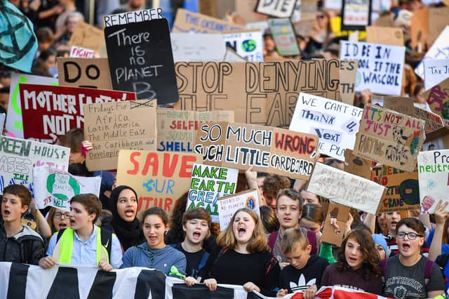 Protesters march and hold placards as they take part in the Global Climate Strike in Edinburgh in 2019 (Picture: Jeff J Mitchell/Getty Images)