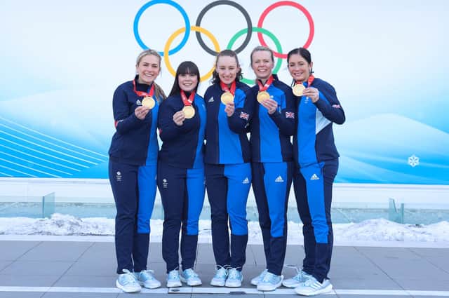 Curlers, from left, Milli Smith, Hailey Duff, Jennifer Dodds, Vicky Wright and Eve Muirhead pose for pictures with their Olympic gold medals after winning the Women's Curling final
