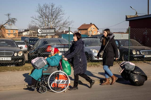 A family is seen after they crossed the Ukrainian-Polish border in Medyka, southeastern Poland on March 19. Picture: Wojtek RADWANSKI / AFP via Getty Images