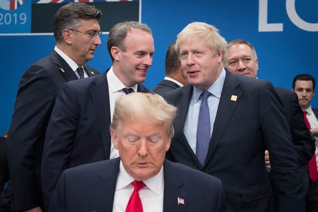 UK Foreign Secretary Dominic Raab and Boris Johnson chat behind Donald Trump at the annual Nato heads of government summit in Watford in December 2019 Picture: Stefan Rousseau/PA