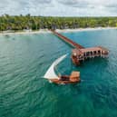A dhow passes a jetty at The Residence