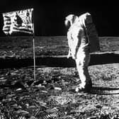 An image showing Astronaut Edwin Aldrin with the flag of the United States planted on the surface of the moon on the Apollo 11 mission.