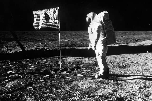 An image showing Astronaut Edwin Aldrin with the flag of the United States planted on the surface of the moon on the Apollo 11 mission.