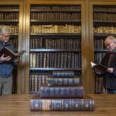 Alistair McDonald, left, and Michael Osborne, right, both guides at the Leighton Library in Dunblane, each pick out a book from the extraordinary collection at Scotland's oldest purpose built library. PIC: Contributed.
