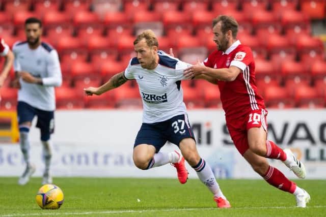 Aberdeen's Niall McGinn (right) battles with Rangers' Scott Arfield during the Scottish Premiership match between Aberdeen and Rangers at Pittodrie on August 01, 2020, in Aberdeen, Scotland. (Photo by Craig Williamson / SNS Group)