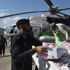 Government officials and security personnel load relief food bags into a government helicopter for flood affected people in Saidu Sharif, the capital of Swat valley in the Khyber Pakhtunkhwa province on August 30, 2022.Photo by Abdul Majeed  via Getty Images