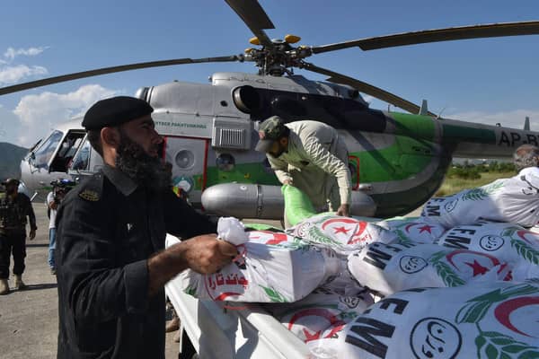 Government officials and security personnel load relief food bags into a government helicopter for flood affected people in Saidu Sharif, the capital of Swat valley in the Khyber Pakhtunkhwa province on August 30, 2022.Photo by Abdul Majeed  via Getty Images