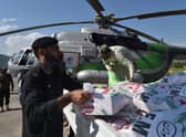 Government officials and security personnel load relief food bags into a government helicopter for flood affected people in Saidu Sharif, the capital of Swat valley in the Khyber Pakhtunkhwa province on August 30, 2022.Photo by Abdul Majeed  via Getty Images