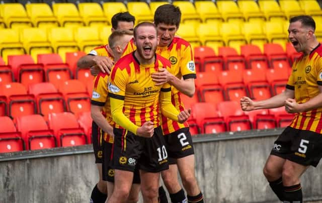 Zak Rudden celebrates scoring the opening goal in Partick Thistle's title-clinching rout of Falkirk at Firhill. (Photo by Craig Foy / SNS Group)