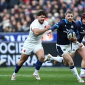 Scotland's scrum-half Finn Russell (C) runs with the ball chased by France's hooker Julien Marchand (L) during the Six Nations clash in Paris.