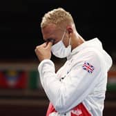 Silver medallist Ben Whittaker reacts on the podium after losing the men's light-heavyweight boxing final. Picture: Buda Mendes/AFP via Getty Images