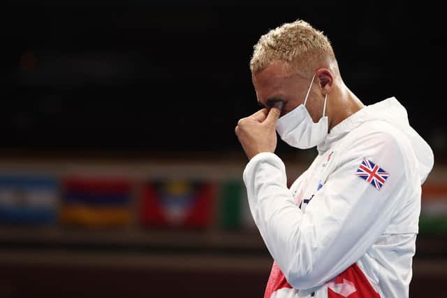 Silver medallist Ben Whittaker reacts on the podium after losing the men's light-heavyweight boxing final. Picture: Buda Mendes/AFP via Getty Images