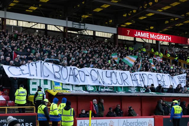 Celtic fans hold up a banner displaying a message to the Celtic board ahead of the 1-1 draw with Aberdeen at Pittodrie. (Photo by Craig Foy / SNS Group)