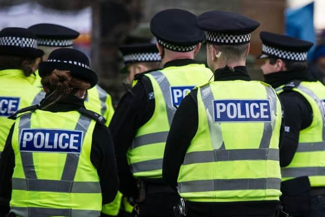 An 18-year-old woman has been charged after two passengers were allegedly assaulted at a train station in North Lanarkshire.