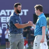 Jon Rahm and Bob  MacIntyre of Scotland shake hands after playing in the DP World Tour Championship last November. Picture: Andrew Redington/Getty Images.