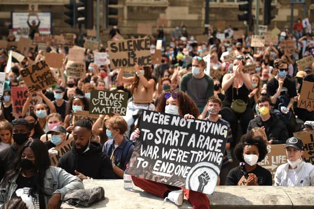 Protesters gather in support of the Black Lives Matter and Black Voices Matter movements in central Leeds on June 14, 2020 in the aftermath of the death of unarmed black man George Floyd in police custody in the US. (Photo by OLI SCARFF/AFP via Getty Images)
