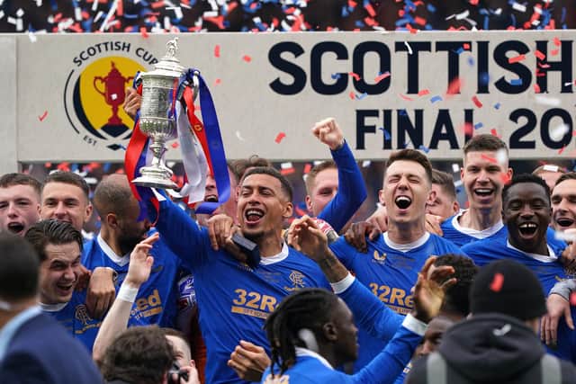 Rangers' James Tavernier (centre) with the trophy following the Scottish Cup final at Hampden Park, Glasgow.