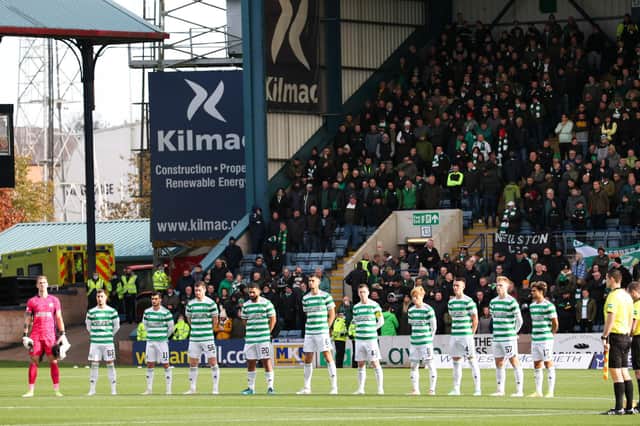 The Celtic players observe a minute silence during the cinch Premiership match against Dundee.