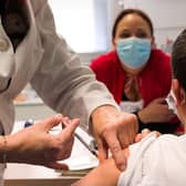 A child receives a dose of Pfizer/BioNTech Covid 19 vaccine. Picture: Sebastien Bozon/AFP via Getty Images