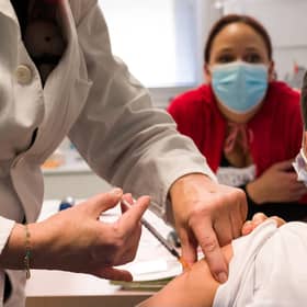 A child receives a dose of Pfizer/BioNTech Covid 19 vaccine. Picture: Sebastien Bozon/AFP via Getty Images