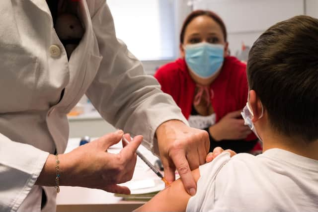 A child receives a dose of Pfizer/BioNTech Covid 19 vaccine. Picture: Sebastien Bozon/AFP via Getty Images