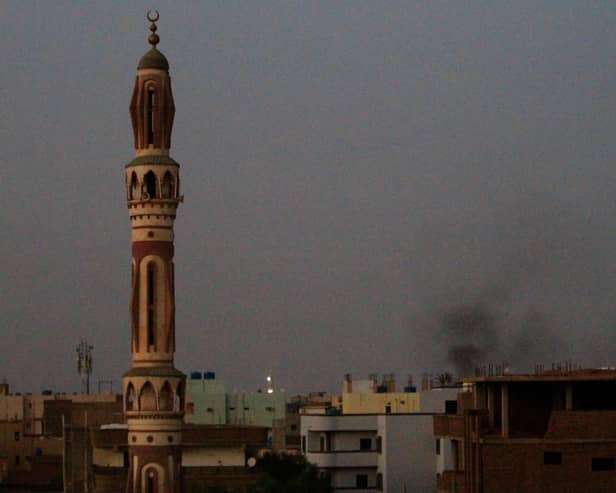 Smoke billows behind buildings in southern Khartoum. Picture: AFP via Getty Images