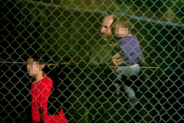 A view of people thought to be migrants at the Manston immigration short-term holding facility located at the former Defence Fire Training and Development Centre in Thanet, Kent. Picture: Gareth Fuller/PA Wire