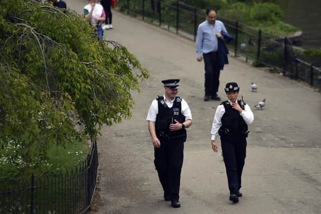 Police officers patrol St James's Park, during lockdown due to the coronavirus outbreak, in London, Thursday, April 16, 2020.