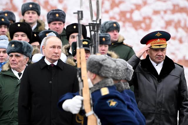Russia's president Vladimir Putin, accompanied by defence minister Sergei Shoigu, attends a wreath-laying ceremony at the Tomb of the Unknown Soldier by the Kremlin Wall in Moscow. Picture: Sergei Savostyanov/AFP via Getty Images