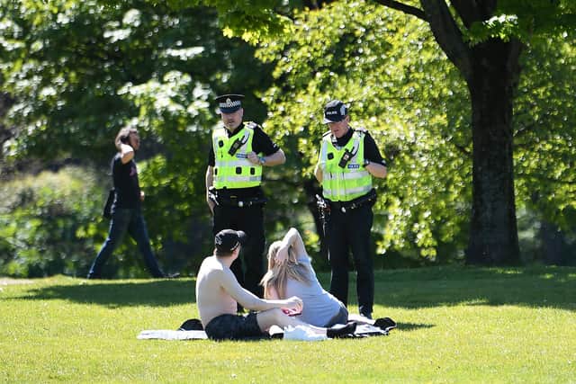 Police speaking to sunbathers on Glasgow Green on 6 May. Picture: John Devlin.