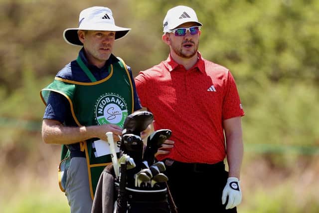 Connor Syme mulls over a shot with his caddie Ryan McGuigan during the first round of the Nedbank Golf Challenge in South Africa. Picture: Warren Little/Getty Images.