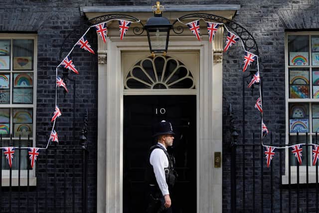 A policeman stands in front of 10 Downing street as bunting covers the facade in central London.