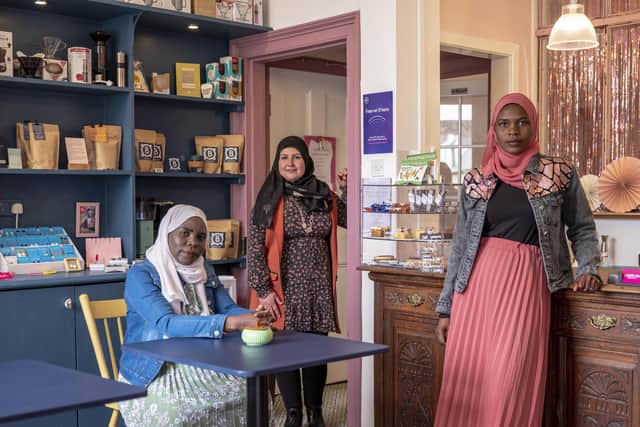 Wafa Murad with Sudanese sisters Sumaia Adam and Hanan Adam Mohamed, in the Bonnie Bling cafe in Rothesay. Photo: Andrew Testa (UNHCR)