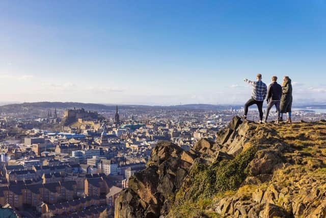 Visitors peer out at the view from Edinburgh's Salisbury Crags. Picture: VisitScotland/Kenny Lam
