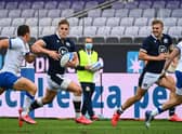 Scotland's Duhan van der Merwe outruns Italy fly-half Paolo Garbisi during last year's Autumn Nations Cup match in Florence. Picture: Vincenzo Pinto/AFP via Getty Images