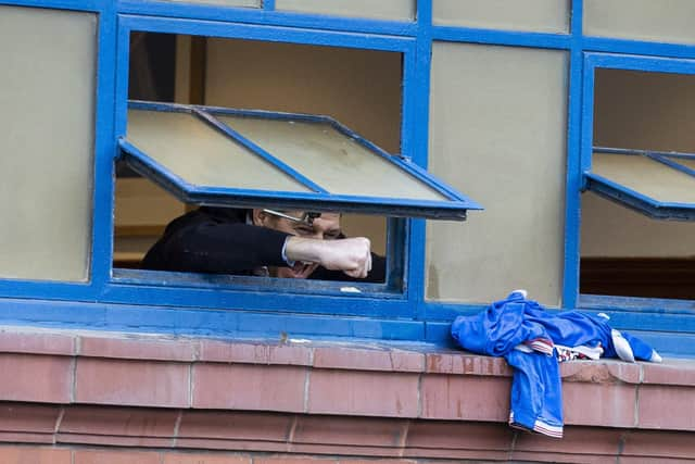 Rangers manager Steven Gerrard celebrates out the dressing room window with fans outside during a Scottish Premiership match between Rangers and St Mirren at Ibrox Stadium, on March 06, 2021, in Glasgow, Scotland. (Photo by Craig Williamson / SNS Group)